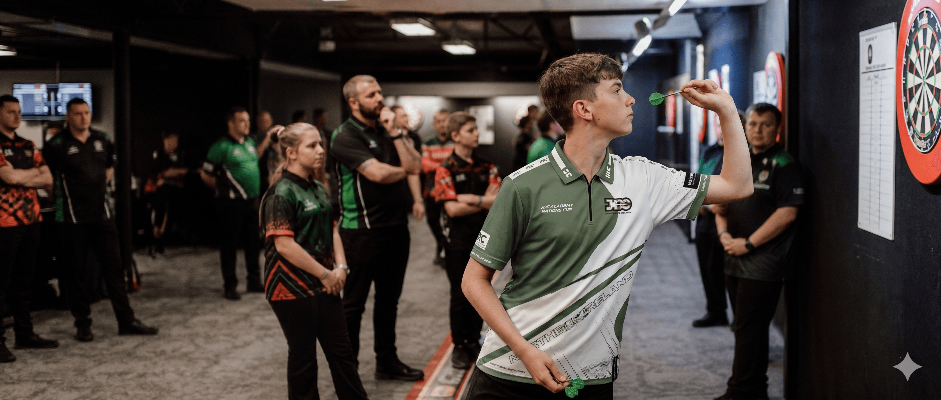 Junior darts players competing at an indoor darts venue